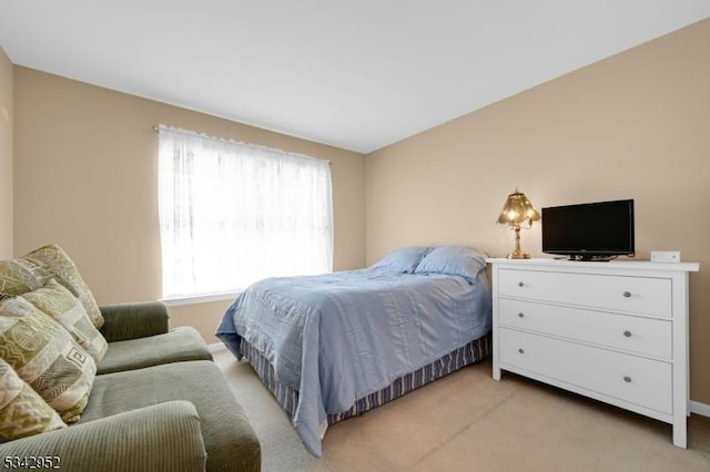 bedroom featuring light colored carpet