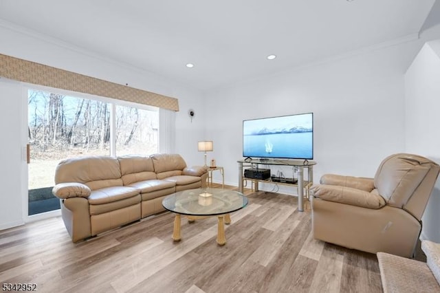 living area with recessed lighting, light wood-style floors, baseboards, and ornamental molding