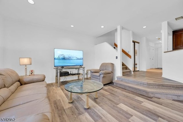 living room with stairs, recessed lighting, light wood-style floors, and visible vents