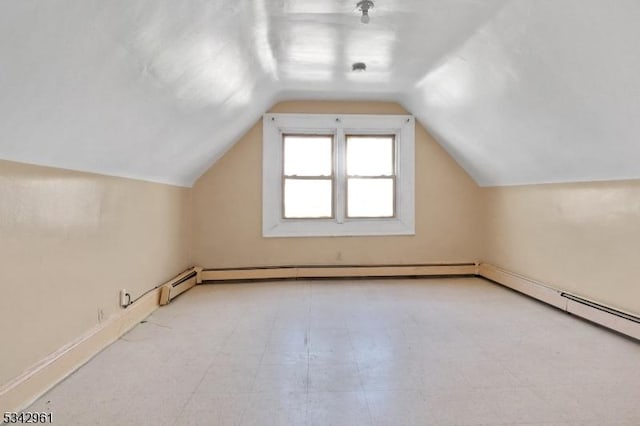 bonus room with tile patterned floors, a baseboard radiator, and lofted ceiling