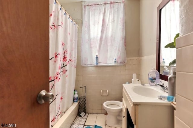 full bathroom featuring vanity, tile walls, plenty of natural light, and tile patterned flooring