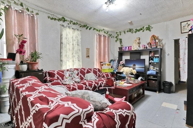 living area featuring a textured ceiling