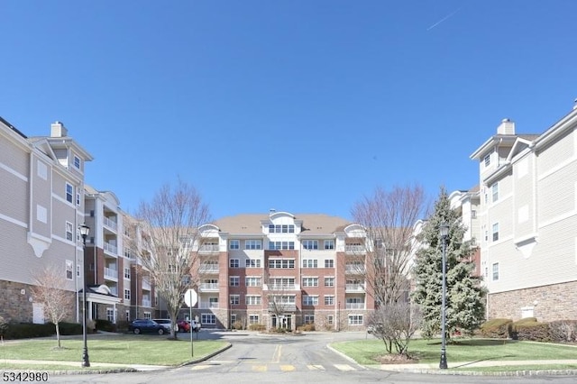 view of building exterior featuring uncovered parking