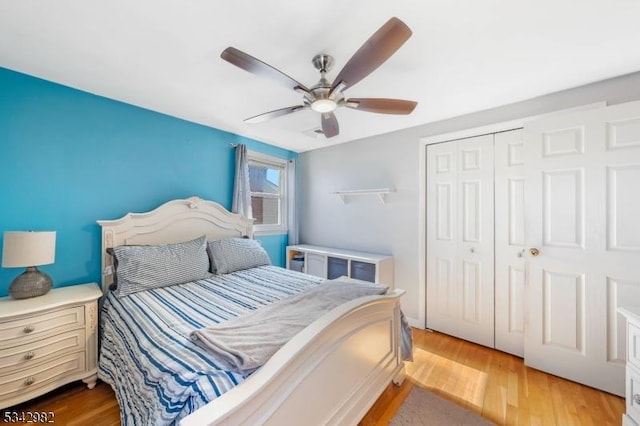 bedroom with a ceiling fan, light wood-type flooring, and a closet