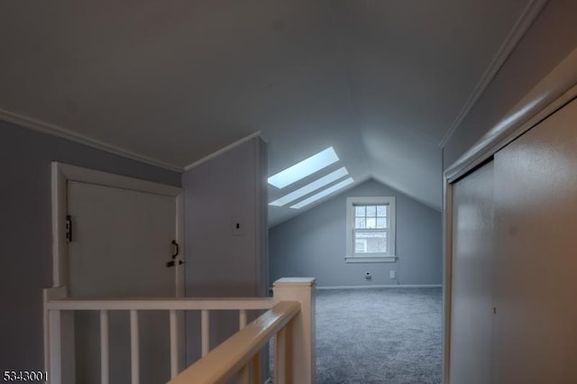 bonus room with lofted ceiling with skylight, baseboards, and carpet floors