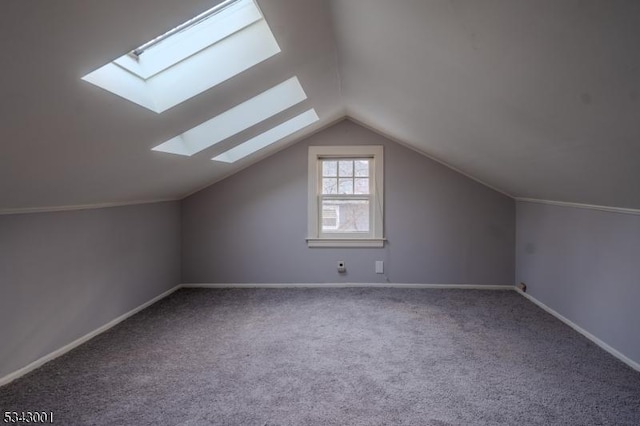 additional living space with baseboards, lofted ceiling, and carpet floors