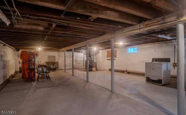 basement featuring water heater and washer / clothes dryer