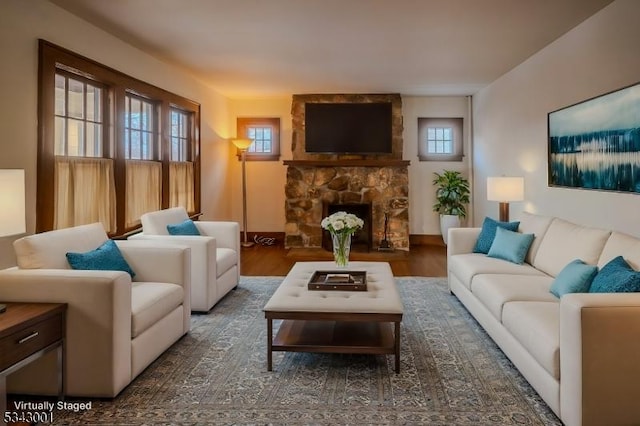 living area featuring wood finished floors and a fireplace