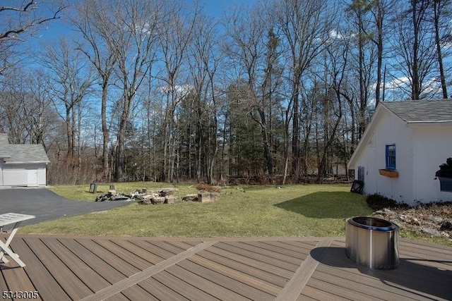 wooden terrace with an outbuilding and a lawn