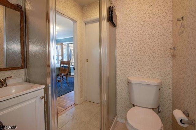 bathroom featuring wallpapered walls, toilet, and vanity