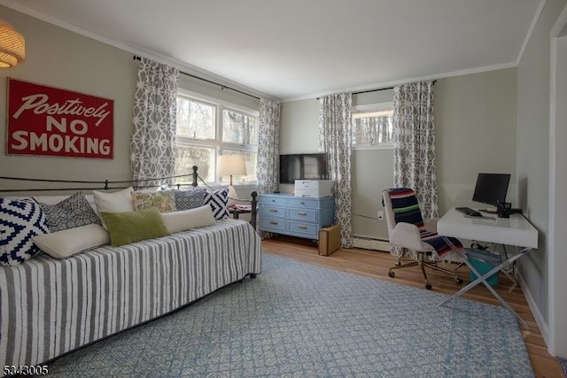 bedroom with a baseboard radiator, crown molding, and wood finished floors