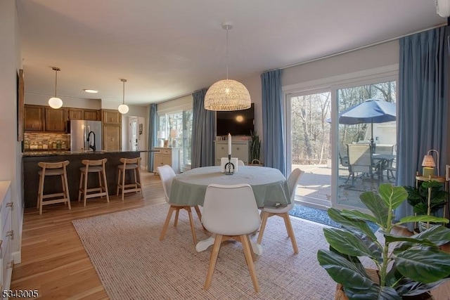 dining space with light wood-style flooring