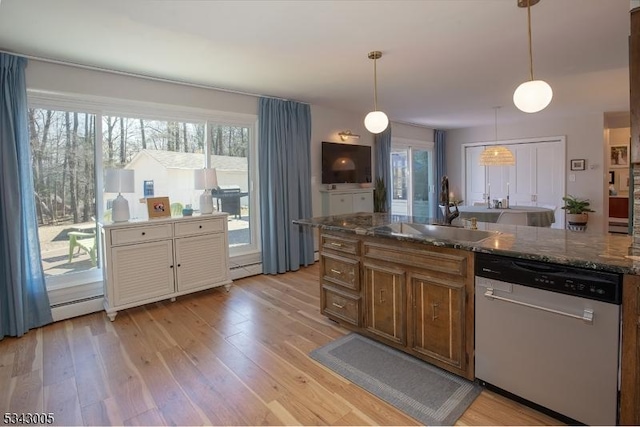 kitchen with dishwasher, light wood-style flooring, plenty of natural light, and a sink