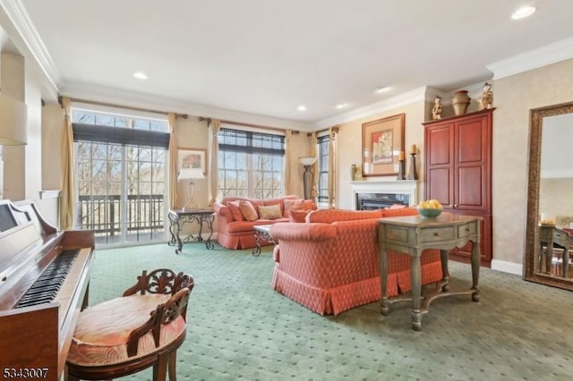 carpeted living area with recessed lighting, baseboards, a glass covered fireplace, and crown molding