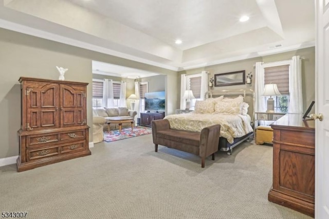 bedroom with baseboards, recessed lighting, ornamental molding, a raised ceiling, and light colored carpet