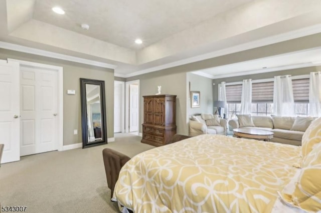 carpeted bedroom featuring recessed lighting, a raised ceiling, baseboards, and ornamental molding