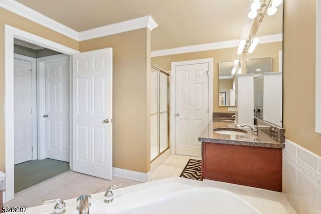 full bath featuring a sink, double vanity, a stall shower, and crown molding