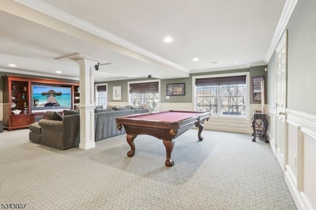 game room with carpet flooring, a wainscoted wall, and ornate columns