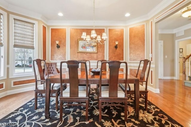 dining room featuring baseboards, a chandelier, ornamental molding, recessed lighting, and wood finished floors