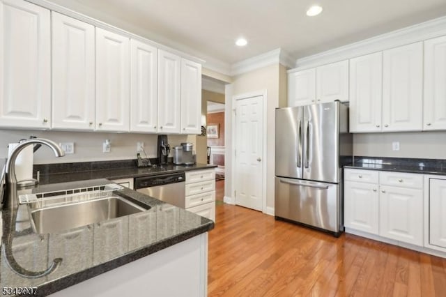 kitchen with white cabinets, appliances with stainless steel finishes, and a sink