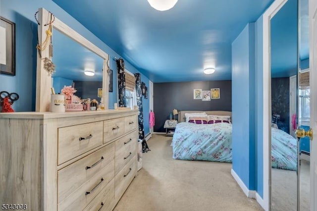 bedroom featuring baseboards and carpet flooring