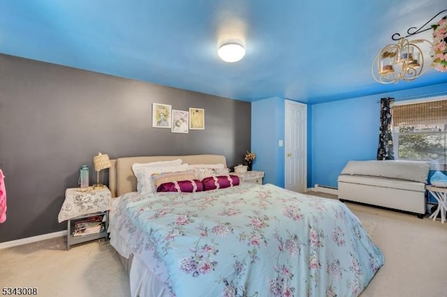 bedroom featuring a baseboard heating unit, carpet, and baseboards