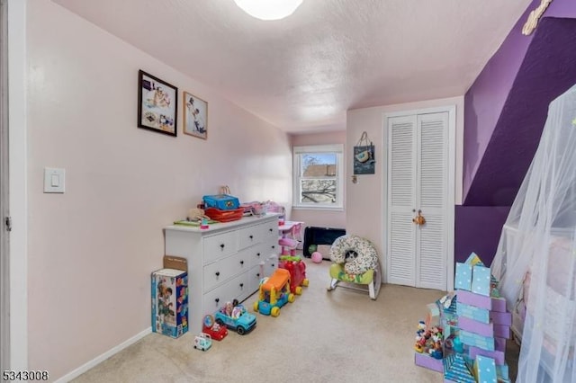 rec room featuring carpet flooring and baseboards