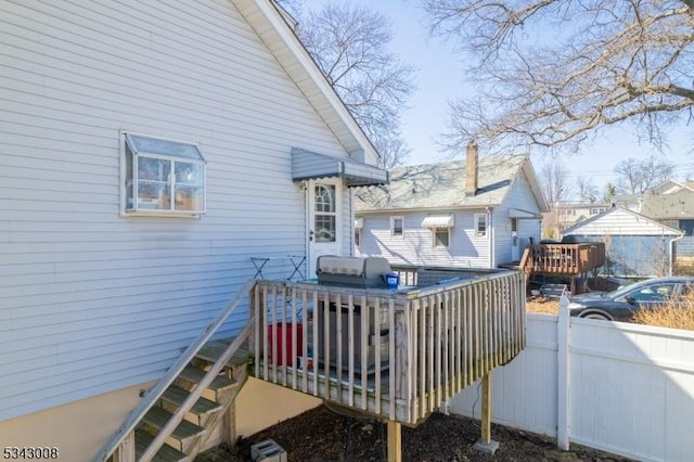 deck with area for grilling and fence