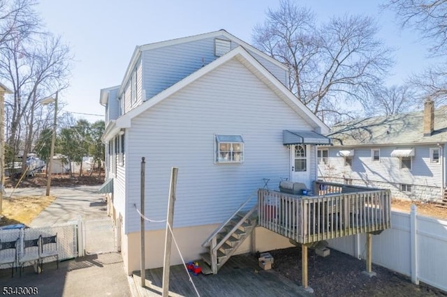 back of house with a gate, a deck, and fence