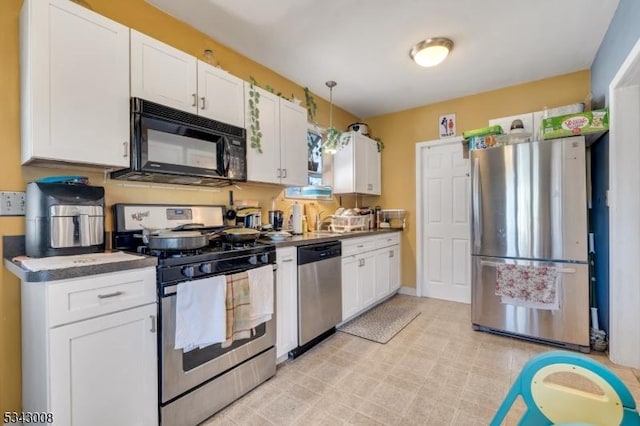 kitchen featuring white cabinetry and appliances with stainless steel finishes