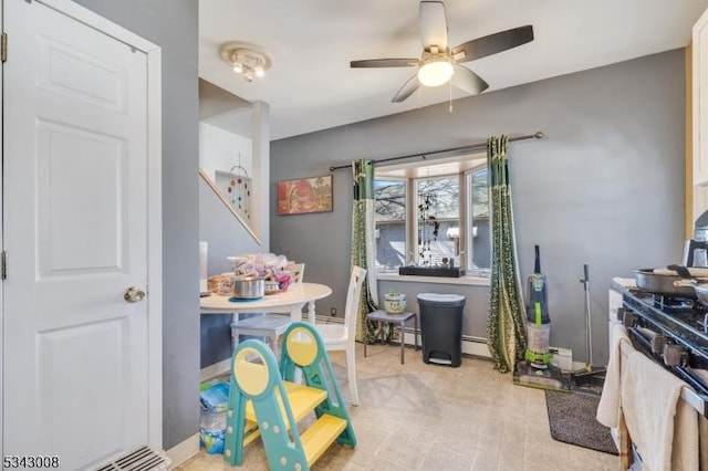 interior space featuring a ceiling fan and baseboards