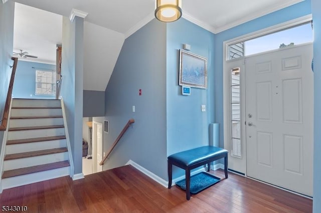 entrance foyer featuring a wealth of natural light, visible vents, wood finished floors, and crown molding