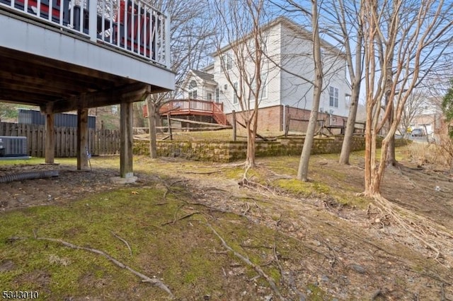 view of yard featuring cooling unit and fence