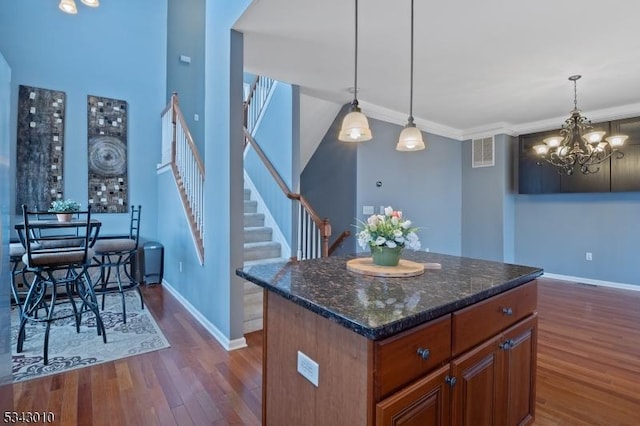 kitchen featuring dark wood finished floors, visible vents, and baseboards