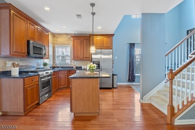 kitchen featuring visible vents, light wood-style flooring, appliances with stainless steel finishes, and a center island