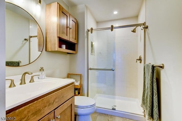 full bathroom with a shower stall, toilet, and vanity