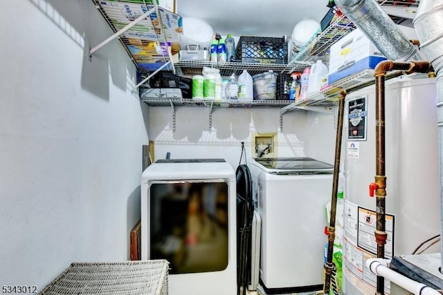 clothes washing area featuring laundry area, gas water heater, and independent washer and dryer