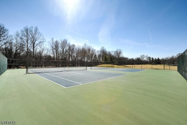 view of tennis court featuring fence