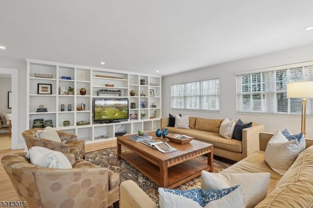 living area with recessed lighting and wood finished floors