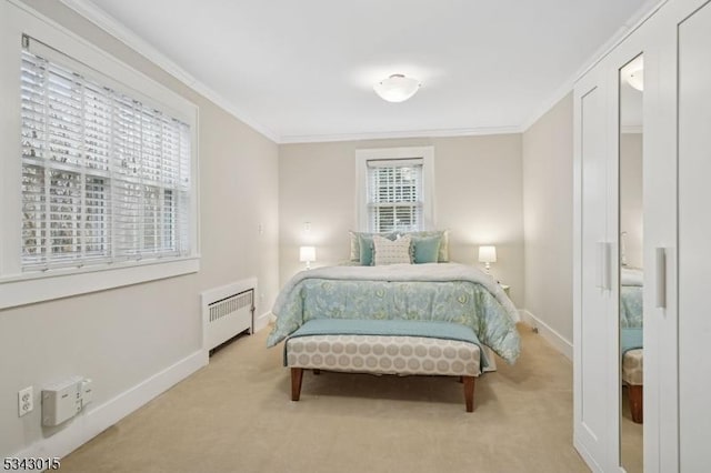 carpeted bedroom with crown molding, radiator, and baseboards