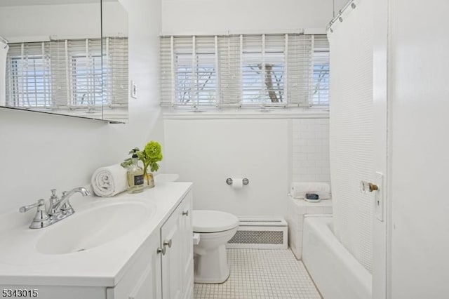 bathroom with toilet, a healthy amount of sunlight, vanity, and tile patterned flooring