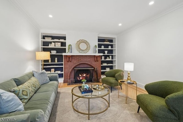 living room with recessed lighting, built in shelves, a fireplace, and crown molding