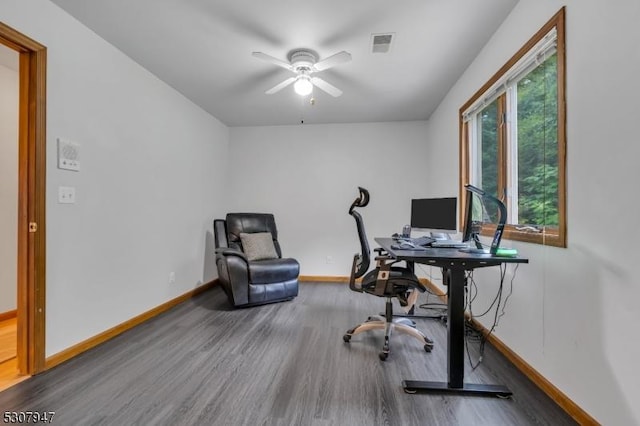 office space featuring ceiling fan, wood finished floors, visible vents, and baseboards