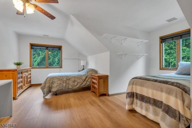 bedroom featuring vaulted ceiling, visible vents, light wood finished floors, and ceiling fan