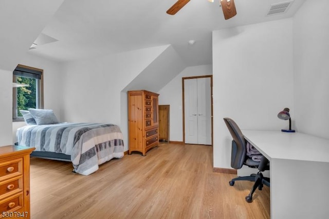 bedroom featuring light wood finished floors, visible vents, baseboards, lofted ceiling, and a ceiling fan