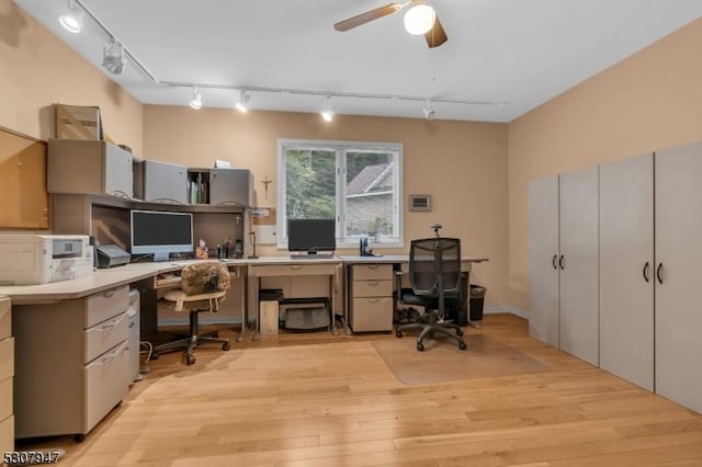 office with light wood-type flooring, track lighting, and a ceiling fan