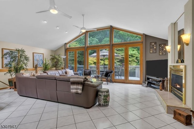 living room with high vaulted ceiling, light tile patterned floors, a fireplace, and ceiling fan