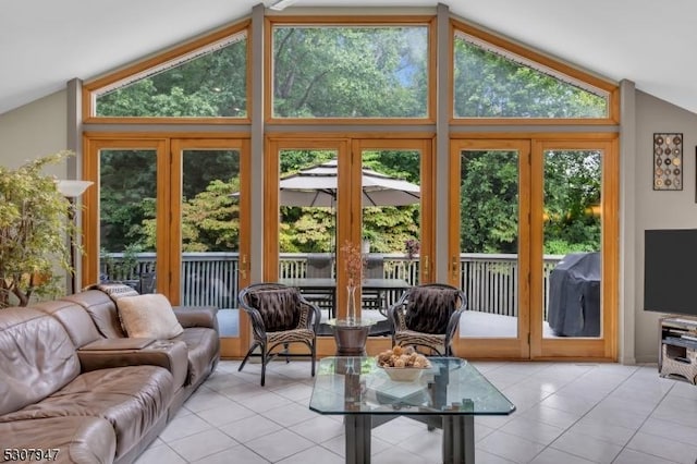 interior space featuring light tile patterned floors and lofted ceiling