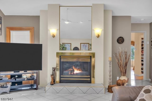 living room with a glass covered fireplace and tile patterned flooring