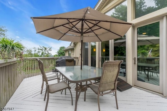 deck featuring area for grilling and outdoor dining space